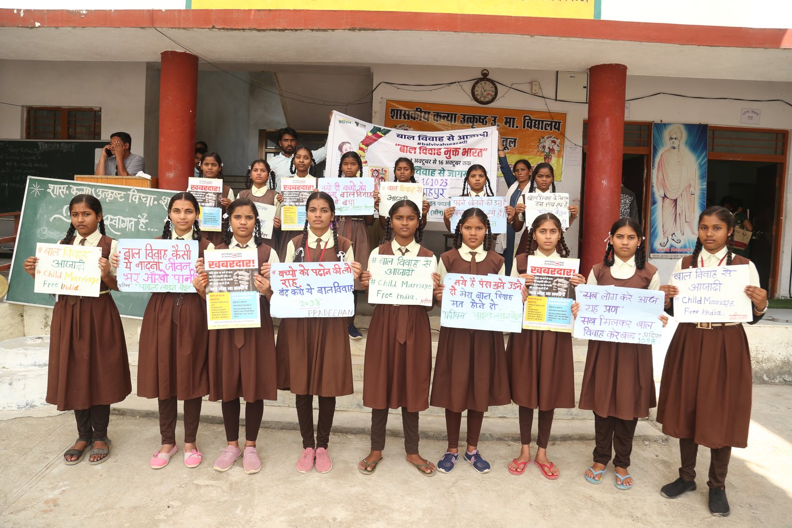 Girls with child marriage awareness banners